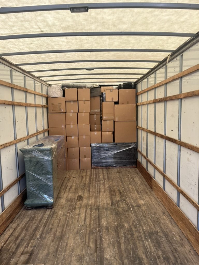 A Tera Moving truck neatly loaded with boxes and wrapped items for a commercial office move