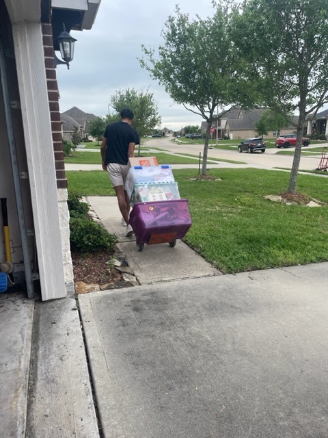 Mover with Trolley Full of Packed Boxes - Expert Moving Services in Sugar Land, Houston