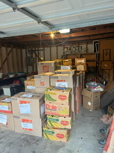 Organized moving boxes stacked in a garage, ready for a seamless relocation with Tera Moving Services.